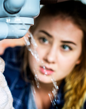 Woman looking at frozen pipe water damage